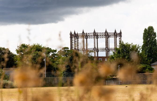 The Great Yarmouth Gas Holder behind buildings with field in the foreground