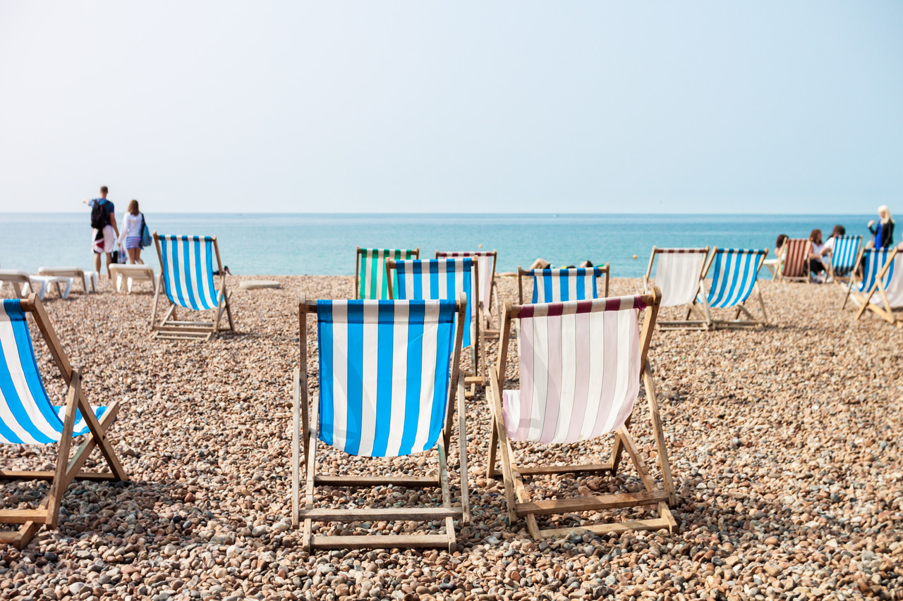 Deck chairs on a pebble beach