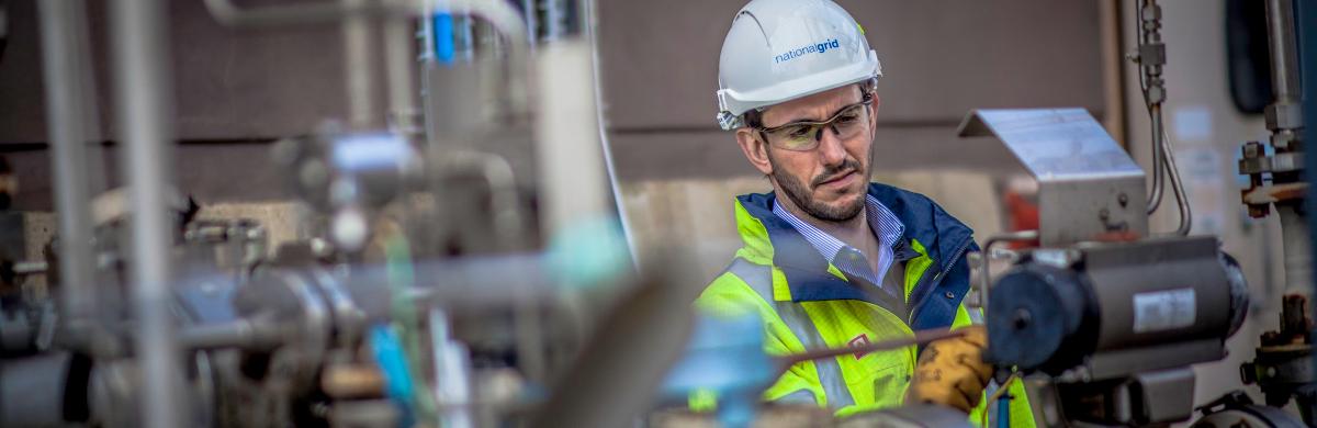 National Grid worker with various pieces of equipment in the foreground and background