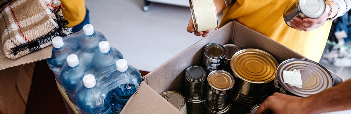 Charity woman with tinned food for National Grid
