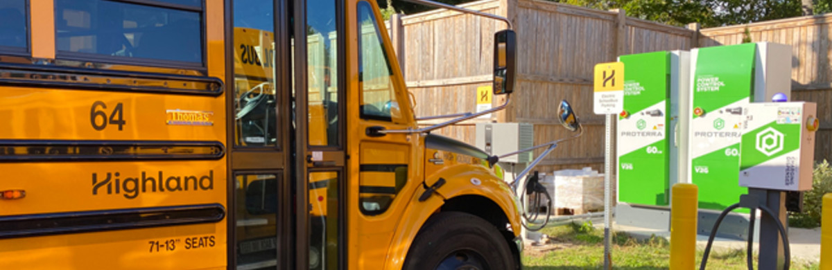 Yellow electric school bus at charging station in Beverly, Massachusetts