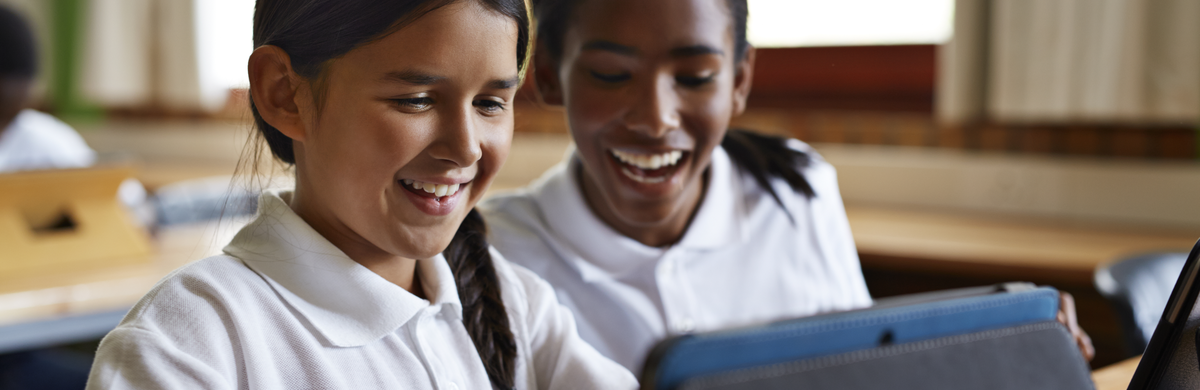 Two children using a tablet