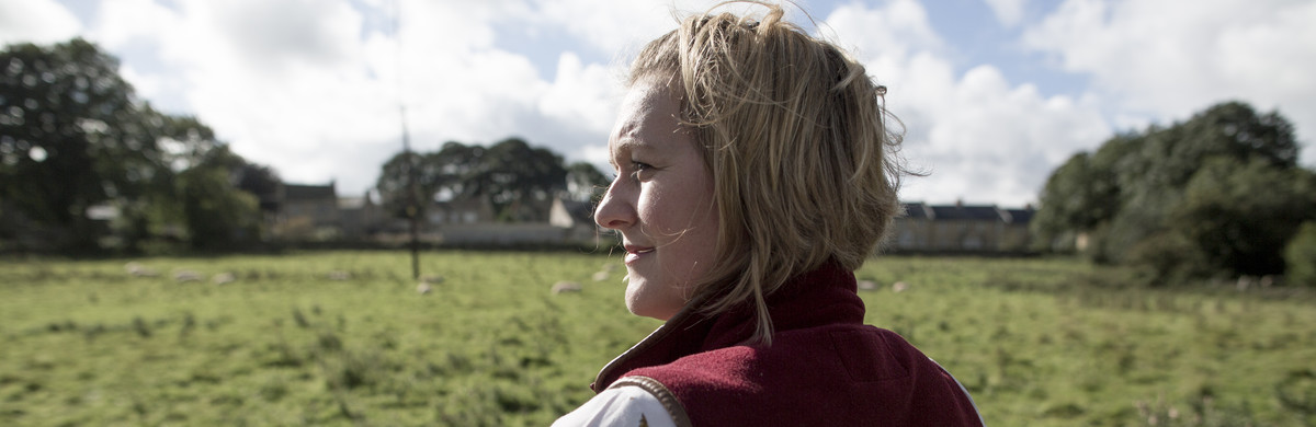 Female farmer looking over land
