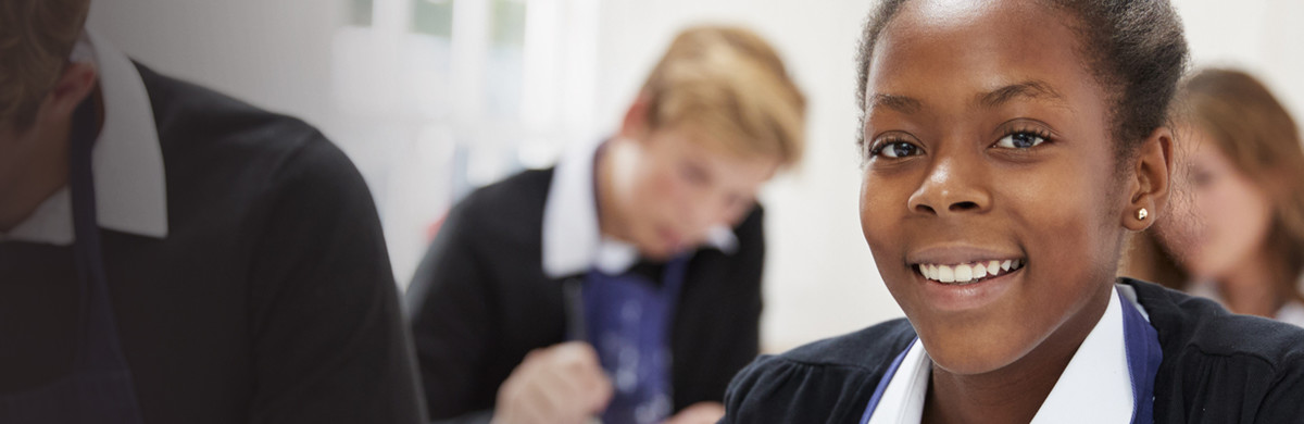 Young female student smiling in class studying climate change