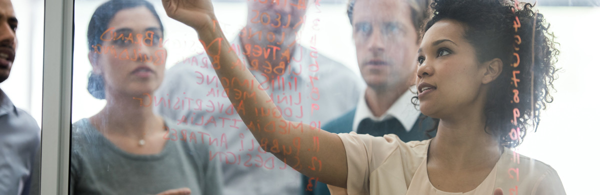 People standing behind glass noticeboard used for National Grid research and development page