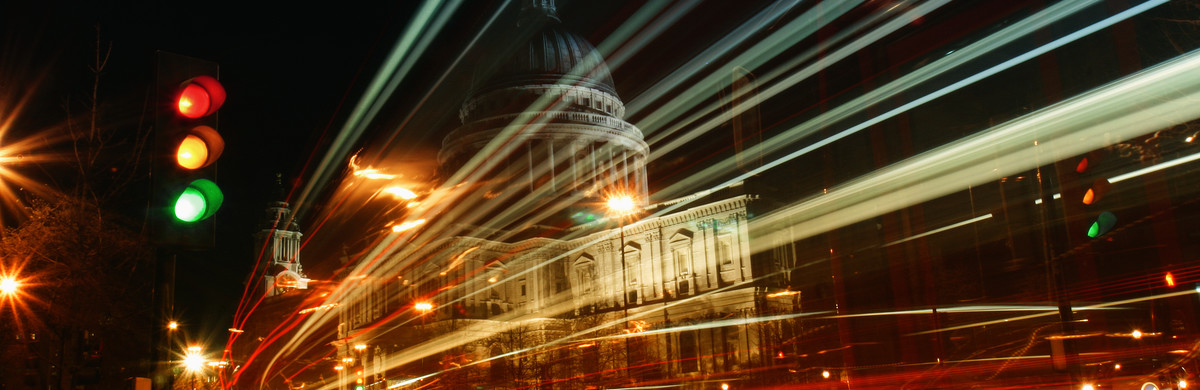 Night-time image of a busy road and traffic lights in a city 