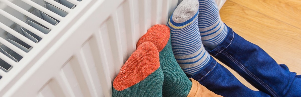 Feet in brightly coloured socks on radiator for National Grid article on Fuel Poverty Awareness Day