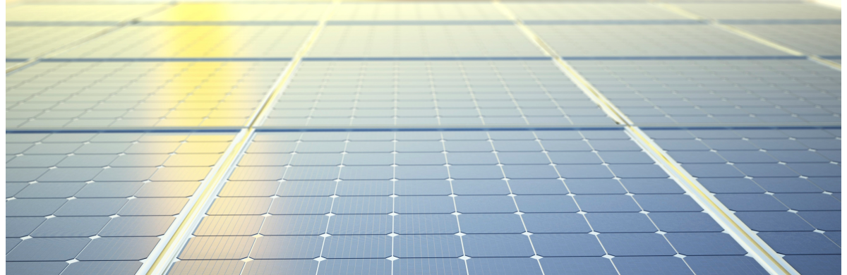 A close up of solar panels with the sun reflecting off them - Building a smarter energy future