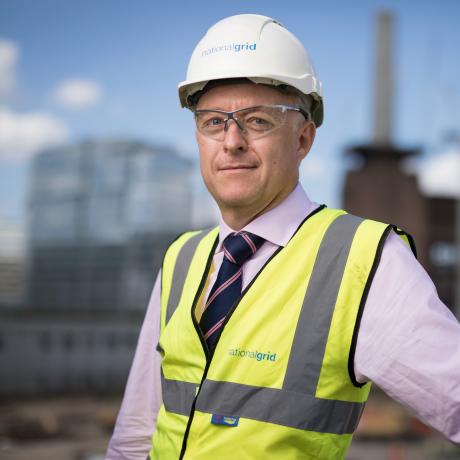 National Grid Head of Real Estate Phil Edwards portrait with out of focus Battersea site in the background