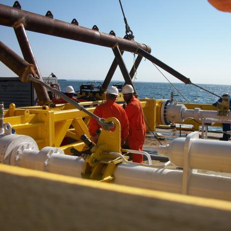 National Grid employees working on a gas rig with the ocean in the background