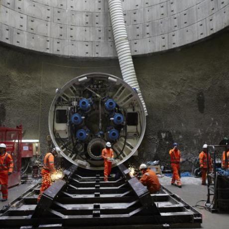 Several Gas industry workers using a tunnel boring machine