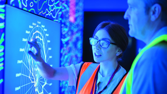 Man and woman viewing digital report