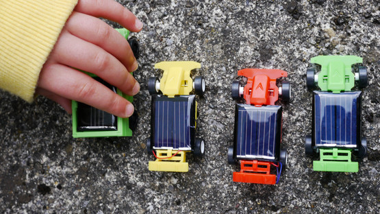 Child playing with toy cars