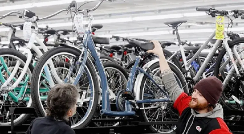 Salesman showing bike to customer