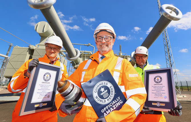 Viking Link project managers wearing PPE and holding Guinness World Record certificates and plaque