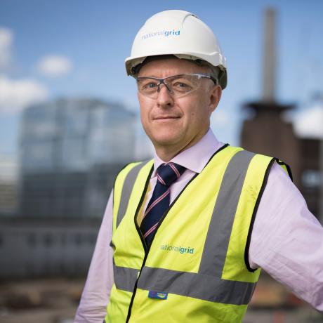 National Grid Head of Real Estate Phil Edwards portrait with out of focus Battersea site in the background 